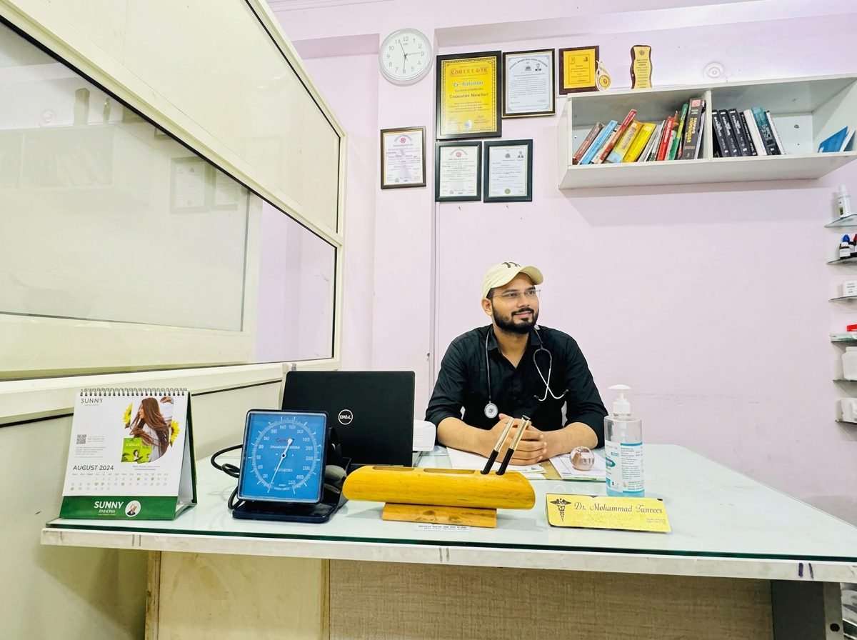 Dr. Mohammad Faizan, homeopathic doctor, at his consultation desk in Jaitpur, New Delhi
